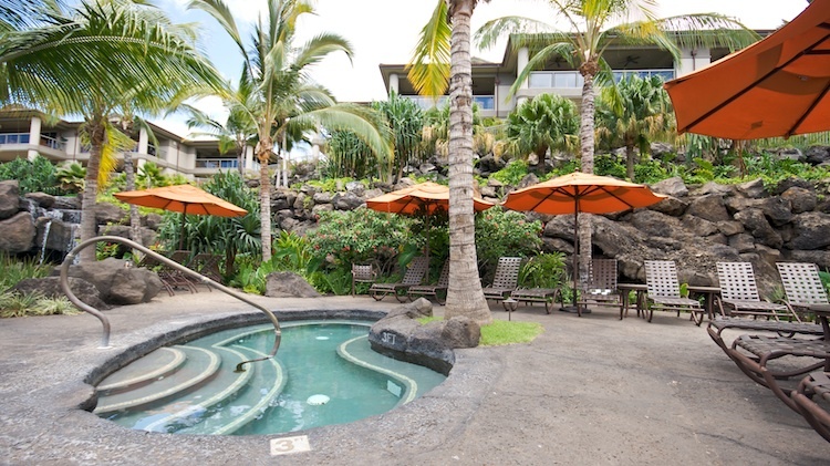Relax outdoors on the pool deck with the sound of waterfalls in the background at Ho'olei