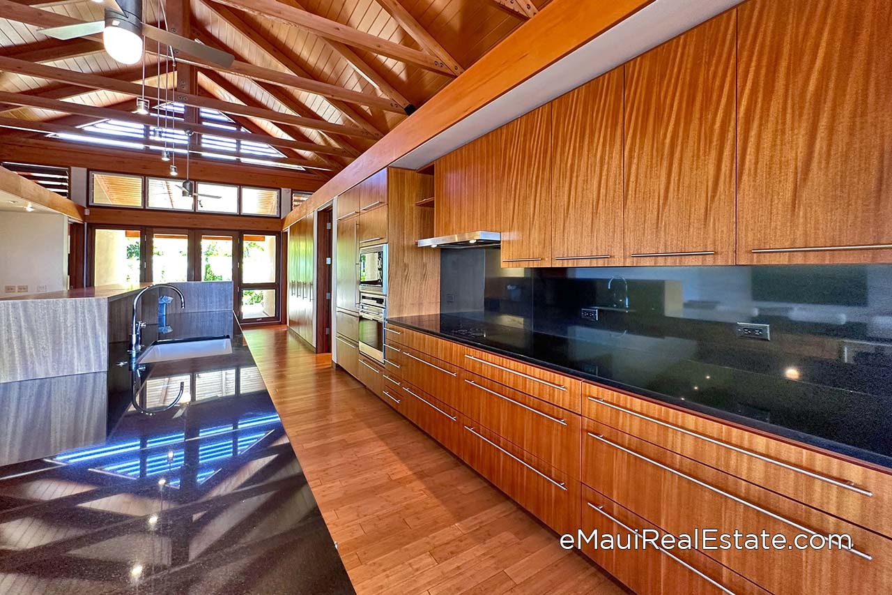 Example of a kitchen at Papali which is rich with beautiful custom wood cabinets and granite counters.